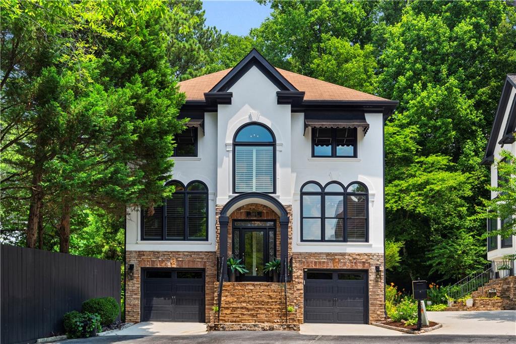 1165 Chantilly Ridge Northeast Atlanta, GA 30324 - Photo 1 of 1 a front view of a house with garden