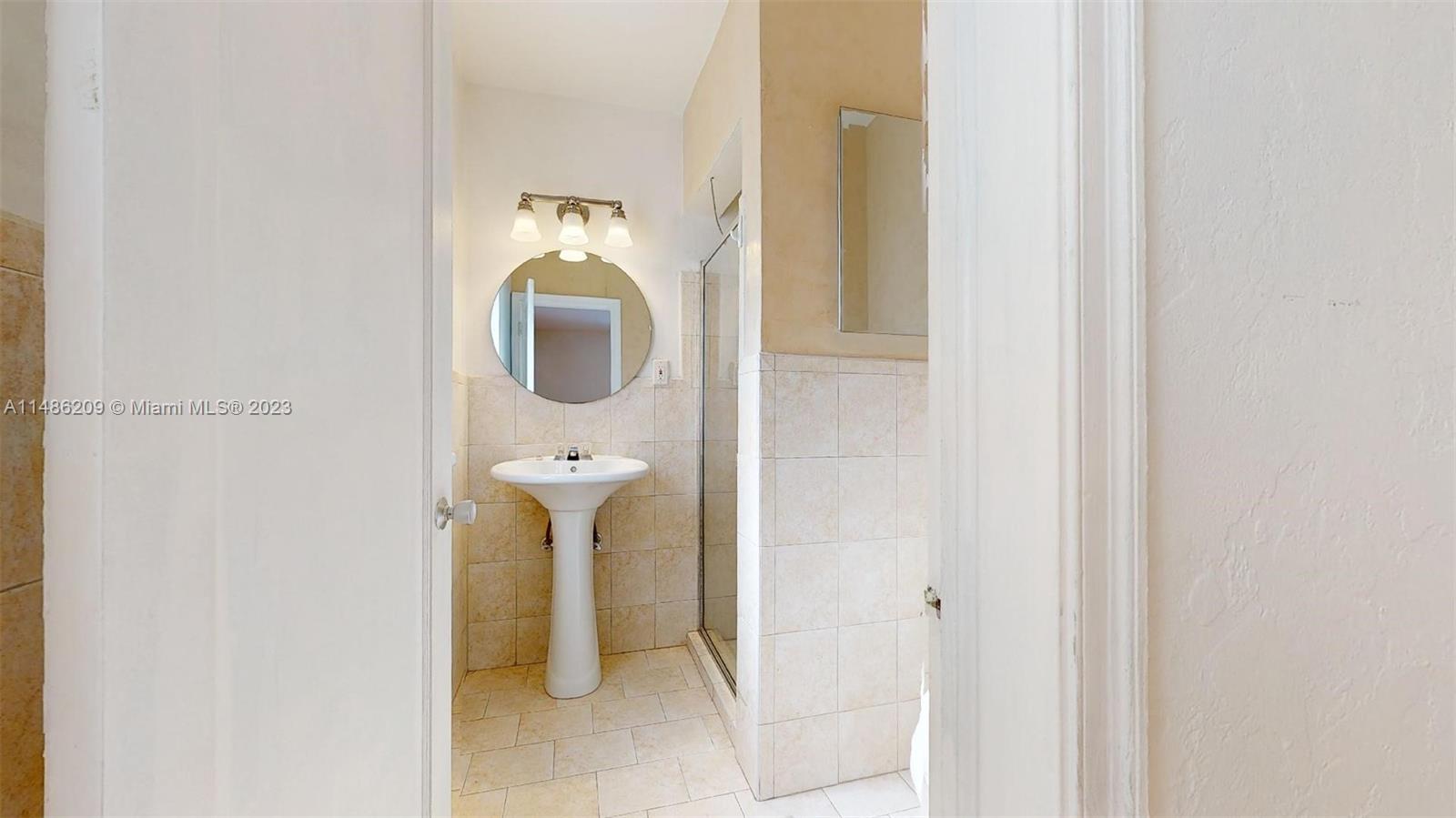 Normandy Beach Surfside, FL 33154 - Photo 12 of 22 a bathroom with a mirror