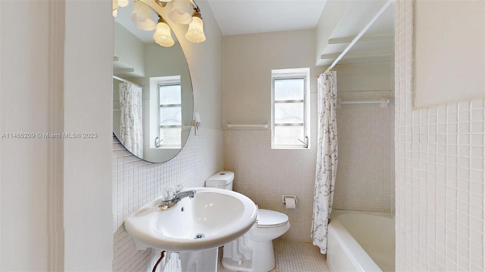 Normandy Beach Surfside, FL 33154 - Photo 15 of 22 a bathroom with a sink a toilet and a mirror