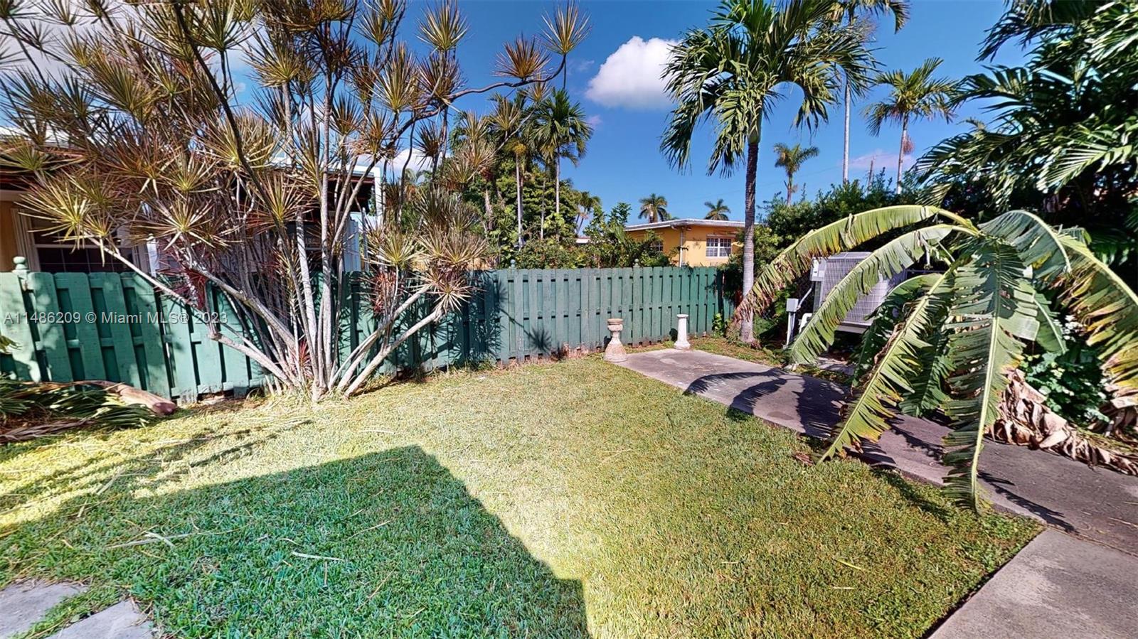 Normandy Beach Surfside, FL 33154 - Photo 20 of 22 a view of a backyard with plants and a slide