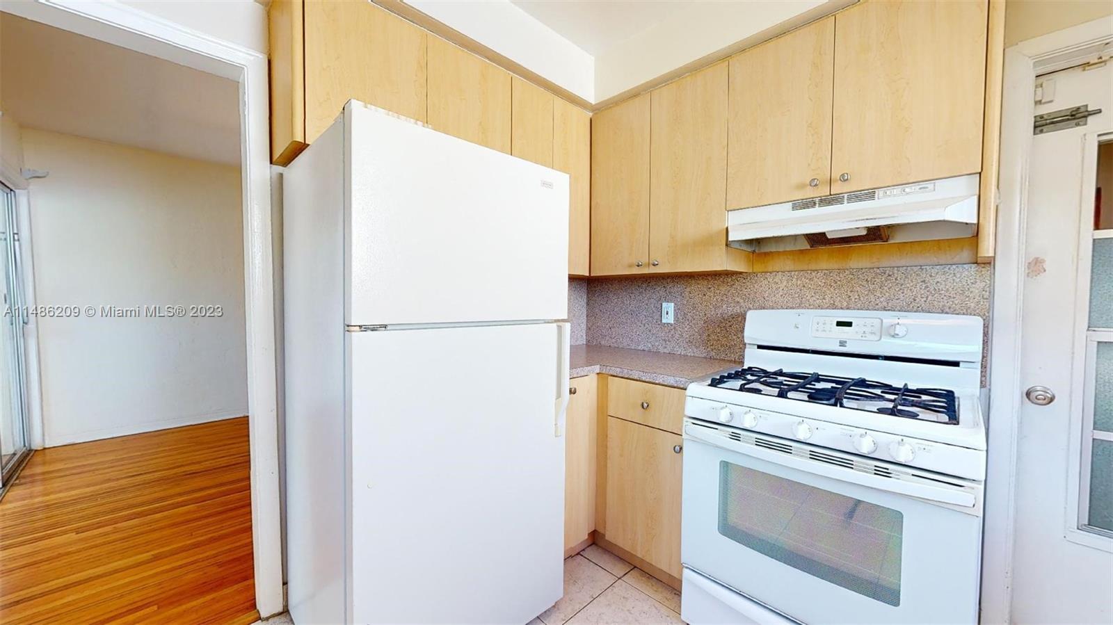 Normandy Beach Surfside, FL 33154 - Photo 9 of 22 a kitchen with a stove and a refrigerator