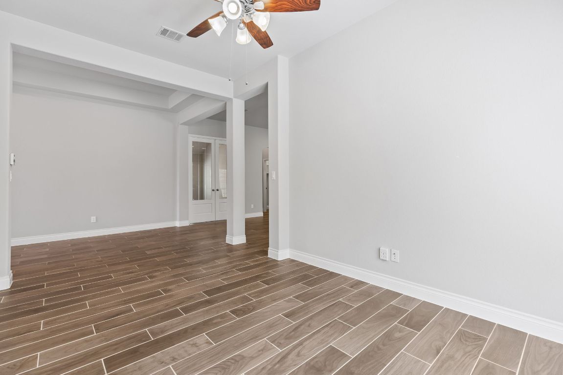 3604 Mercer Road Georgetown, TX 78628 - Photo 11 of 39 a view of a room with wooden floor and fan