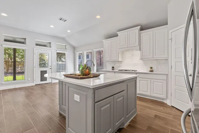 a kitchen with sink stove and cabinets