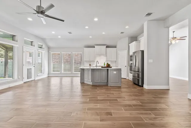 a view of a kitchen with a sink and a window