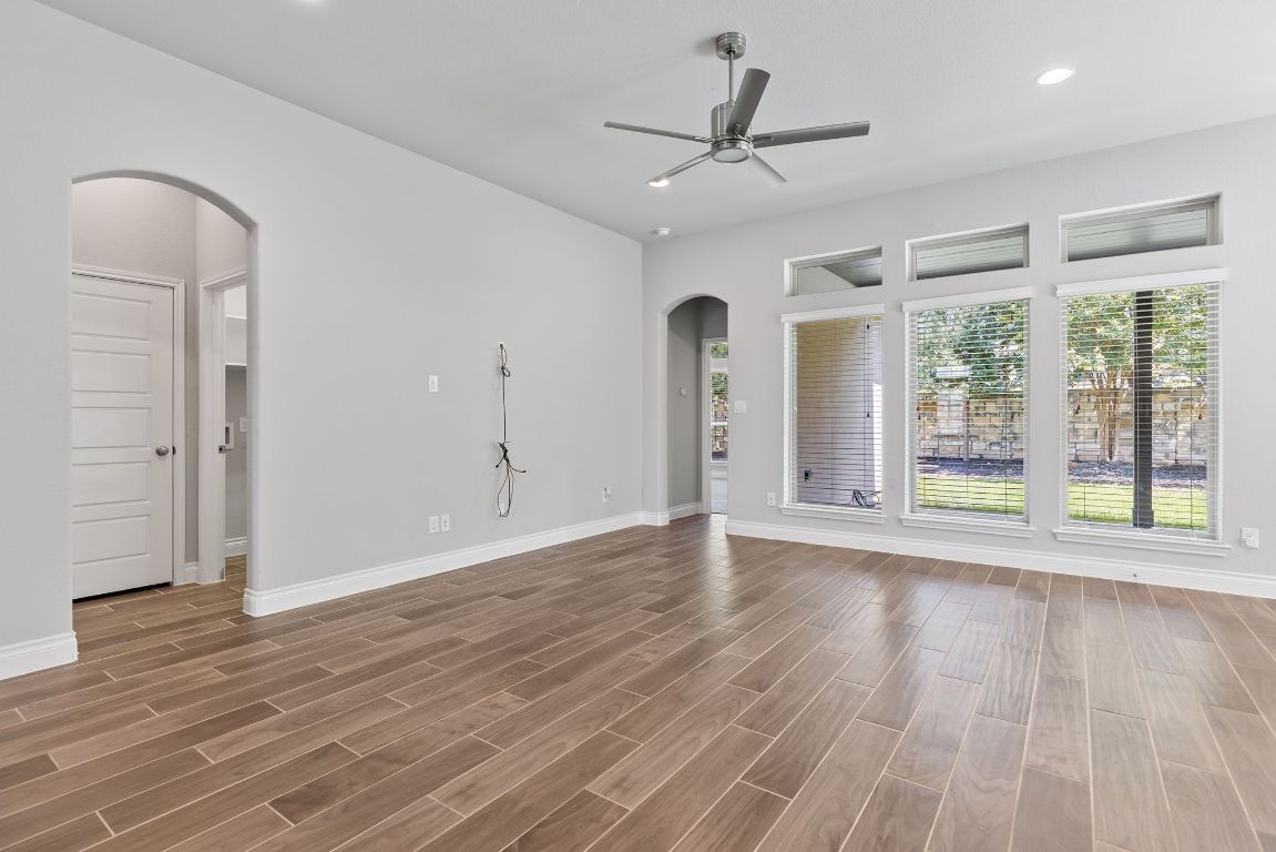 3604 Mercer Road Georgetown, TX 78628 - Photo 18 of 39 a view of an empty room with wooden floor and a window