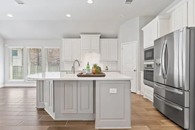a kitchen with granite countertop a refrigerator and a sink