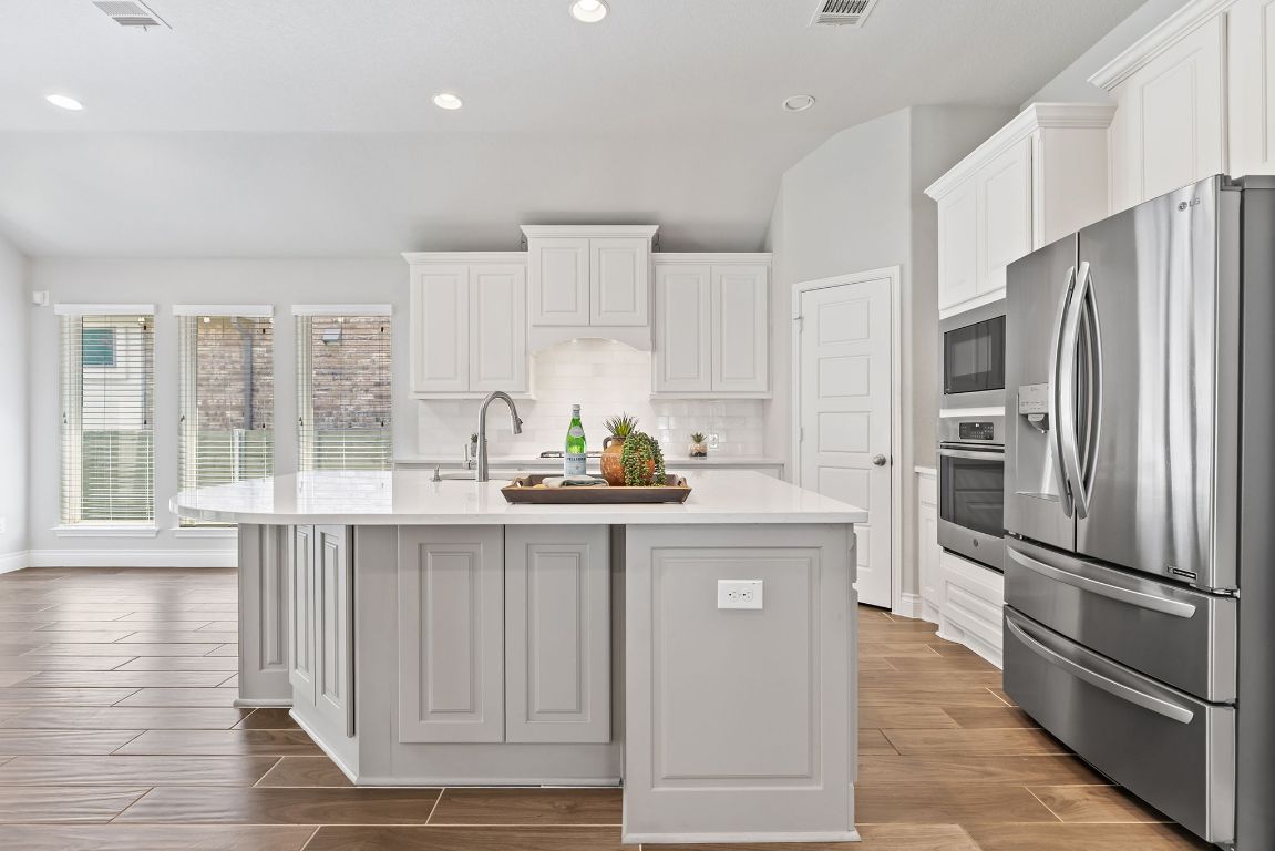 3604 Mercer Road Georgetown, TX 78628 - Photo 2 of 39 a kitchen with granite countertop a refrigerator and a sink