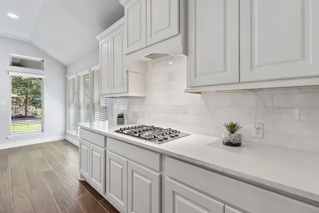 a kitchen with stainless steel appliances white cabinets white stove a sink and dishwasher