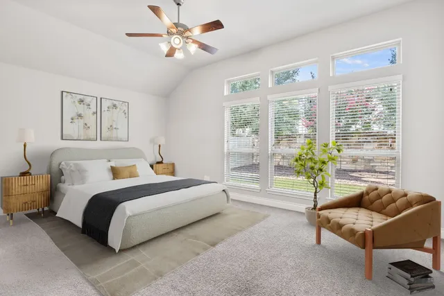 a spacious bedroom with a bed and a couch