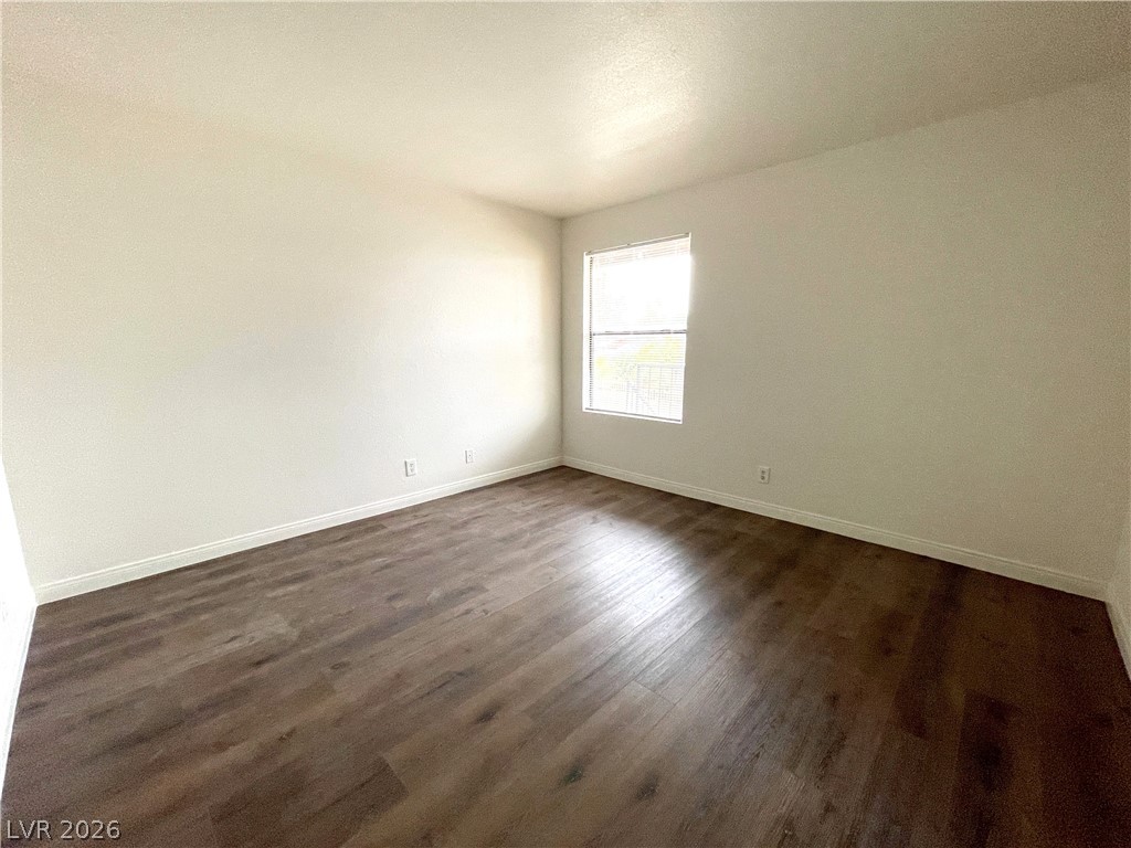 3135 South Mojave Road, Unit 221 Las Vegas, NV 89121 - Photo 11 of 19 Wood flooring and a window create a comfortable, inviting interior space.