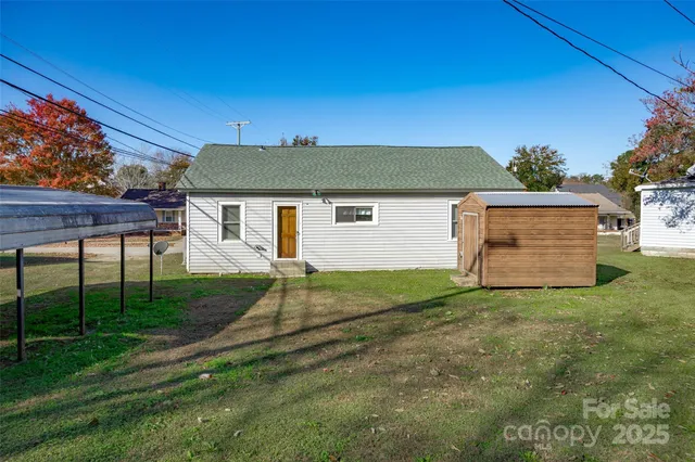 a backyard of a house with table and chairs
