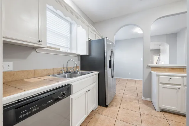 a kitchen with a sink cabinets and appliances