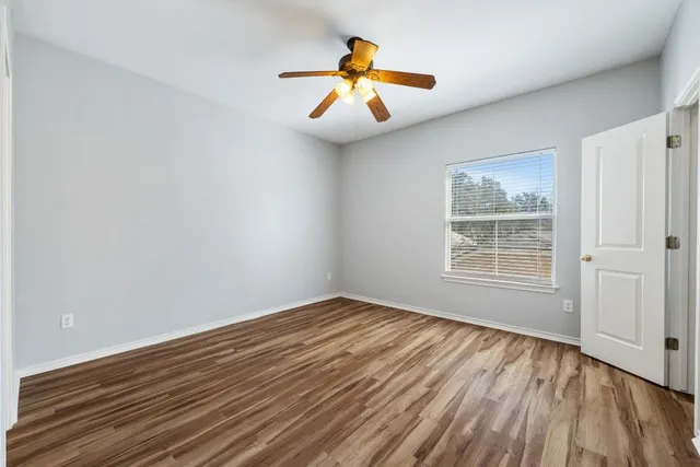 wooden floor in an empty room with a window