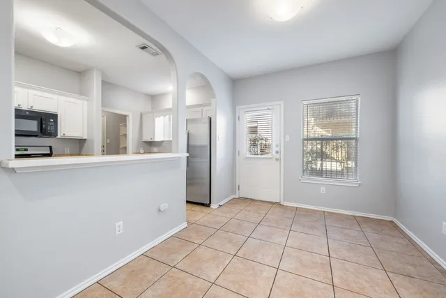 a view of a kitchen with a sink and a window