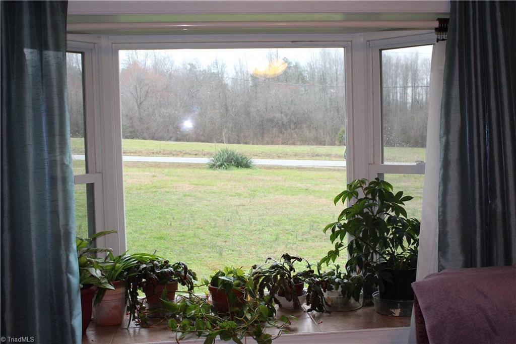 1409 Ritters Lake Road Greensboro, NC 27406 - Photo 10 of 14 Beautiful bay window is great for plants and looks out on the front yard and field across the street.