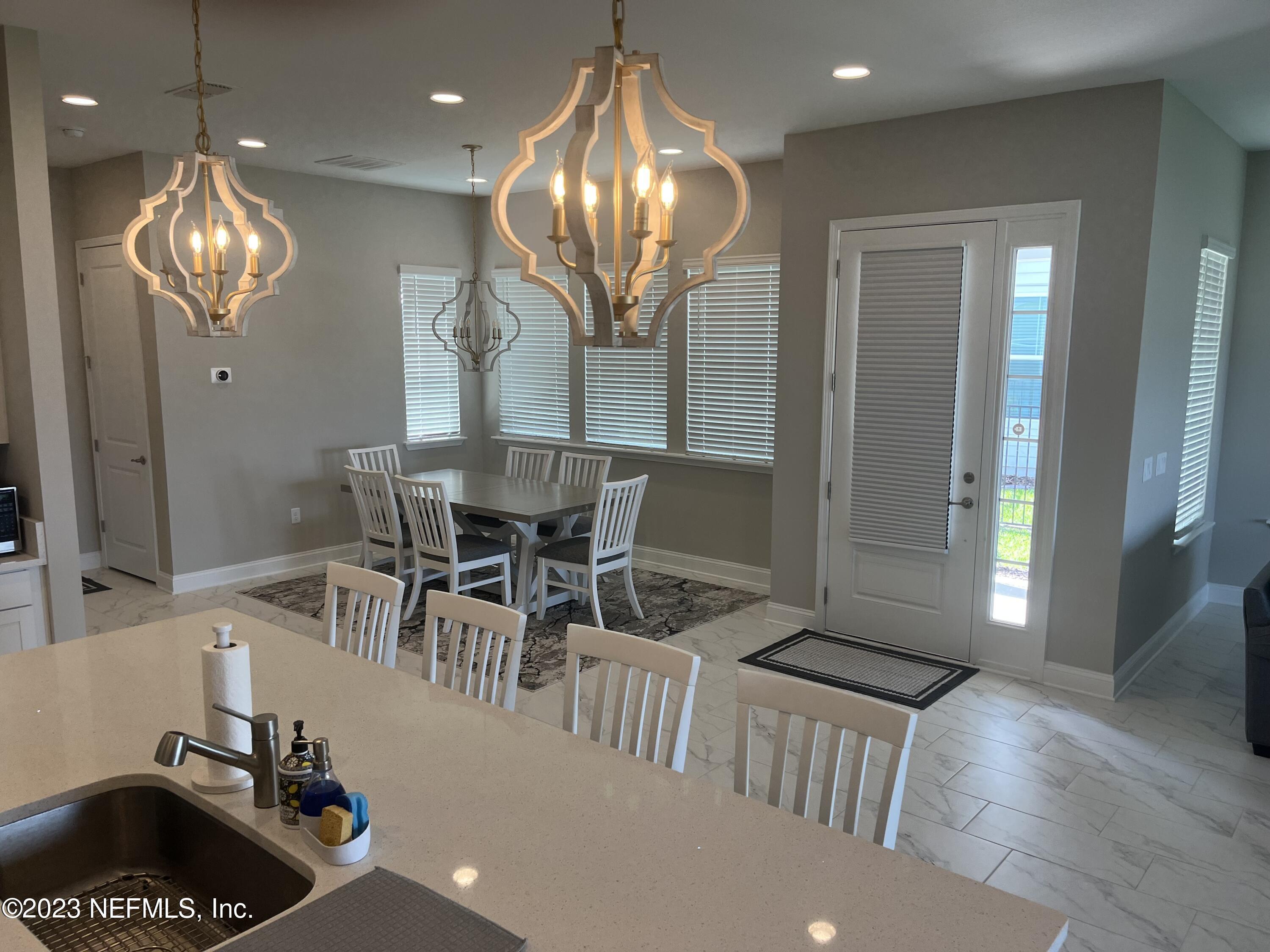 481 Marquesa Circle St. Johns, FL 32259 - Photo 15 of 53 a view of a dining room with furniture and chandelier