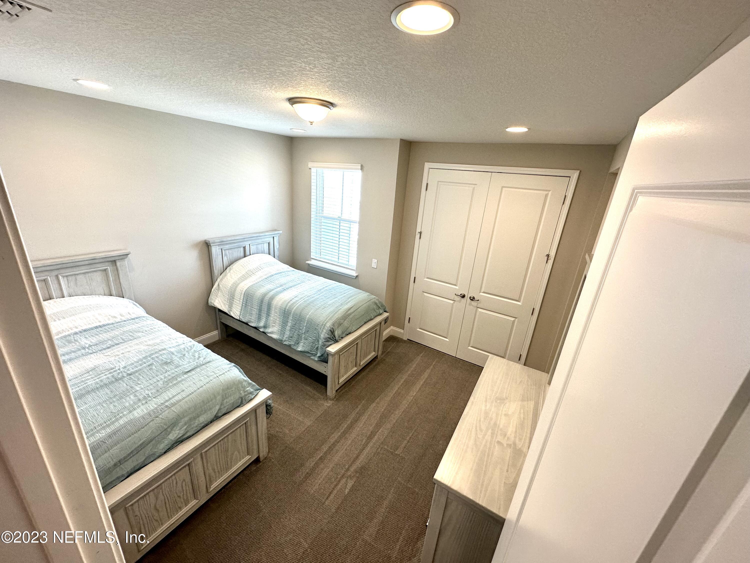 481 Marquesa Circle St. Johns, FL 32259 - Photo 26 of 53 a bedroom with two beds and a window