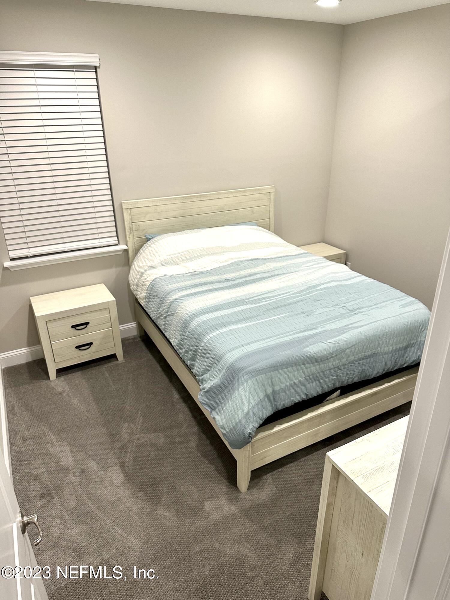 481 Marquesa Circle St. Johns, FL 32259 - Photo 30 of 53 a bed sitting in a bedroom next to a window