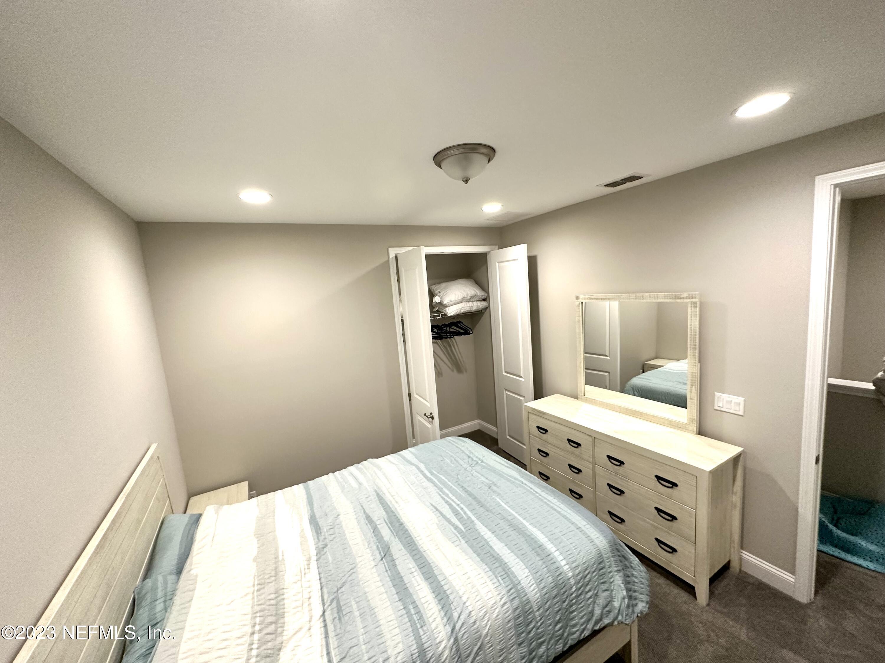 481 Marquesa Circle St. Johns, FL 32259 - Photo 31 of 53 a bedroom with a bed and a mirror