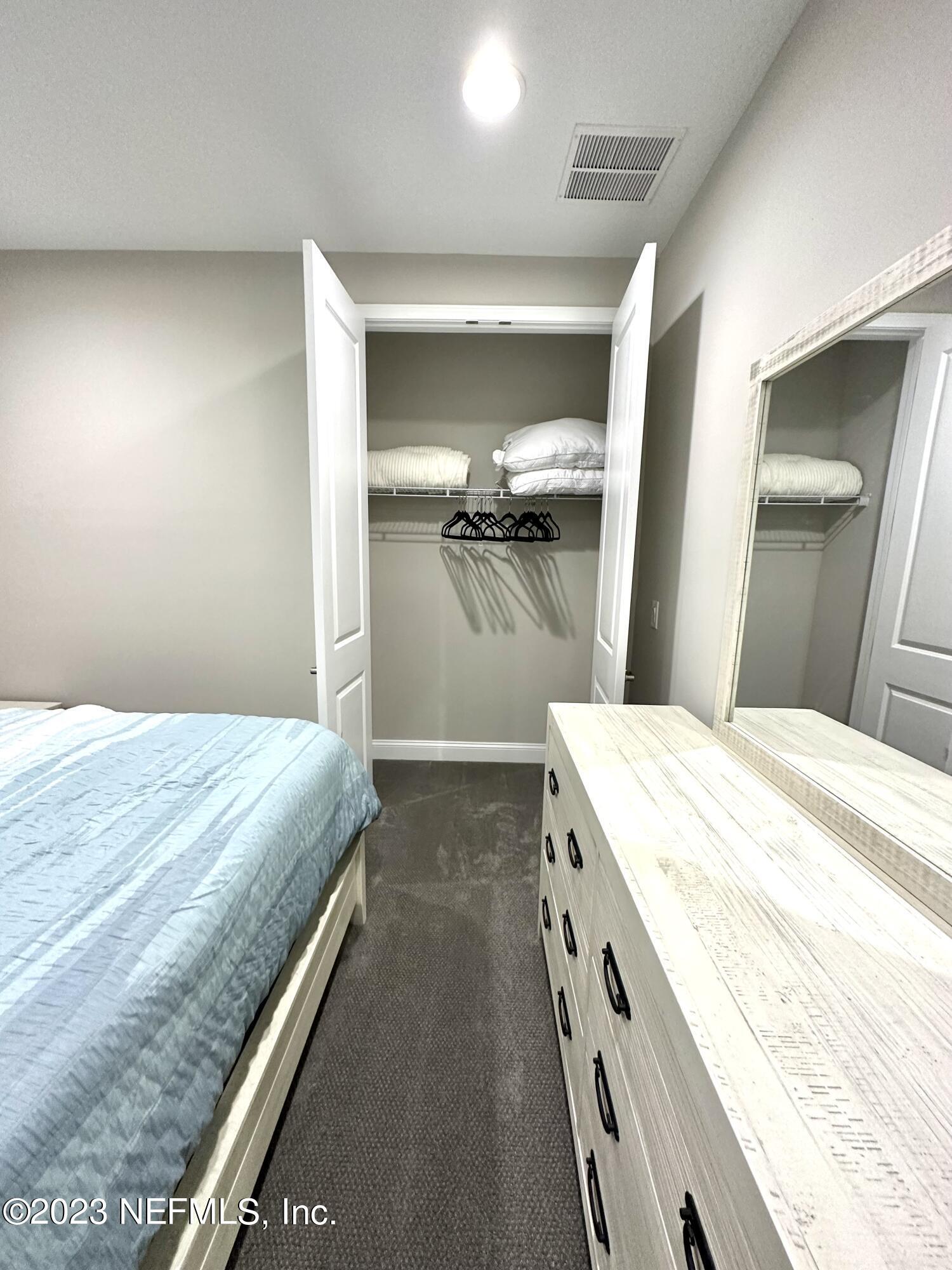 481 Marquesa Circle St. Johns, FL 32259 - Photo 32 of 53 a bathroom with a granite countertop sink a vanity and mirror