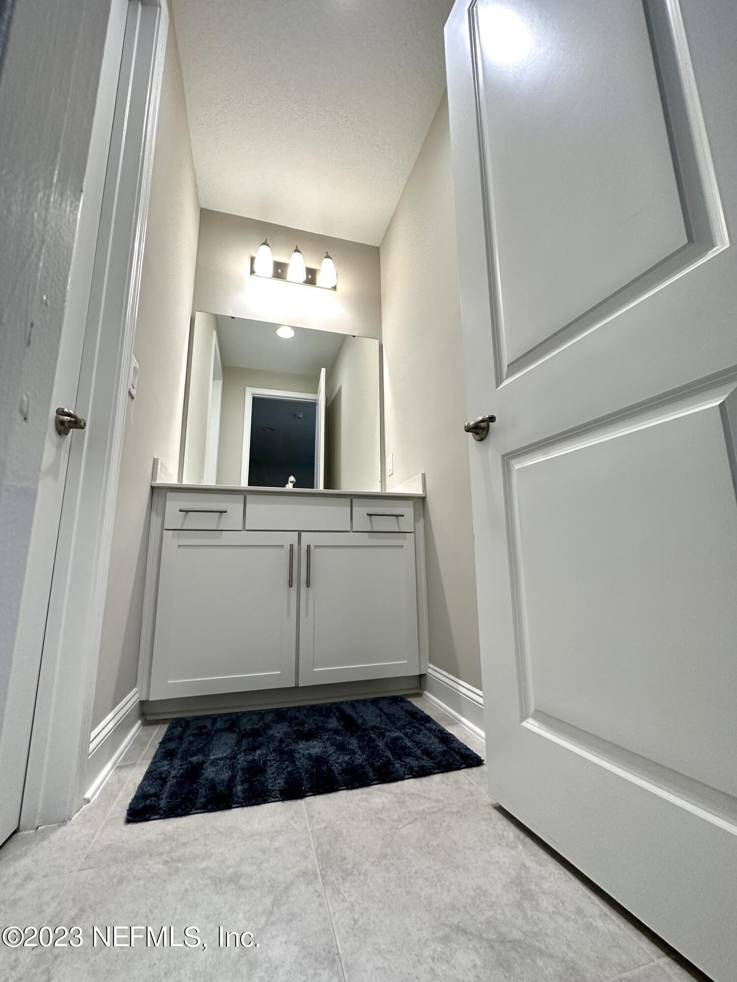 481 Marquesa Circle St. Johns, FL 32259 - Photo 34 of 53 a bathroom with a sink a mirror and vanity