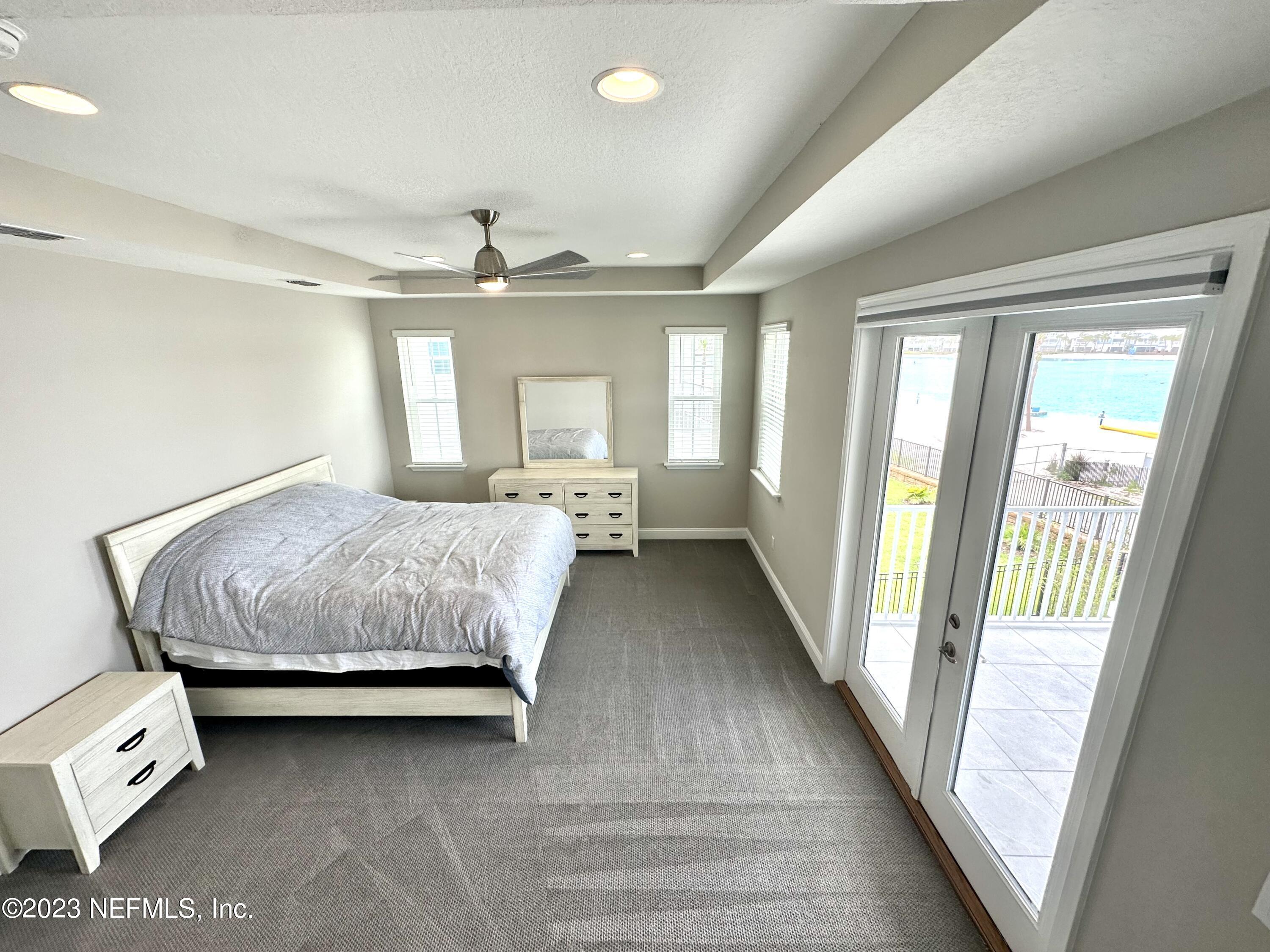 481 Marquesa Circle St. Johns, FL 32259 - Photo 42 of 53 a spacious bedroom with a large bed and a chandelier