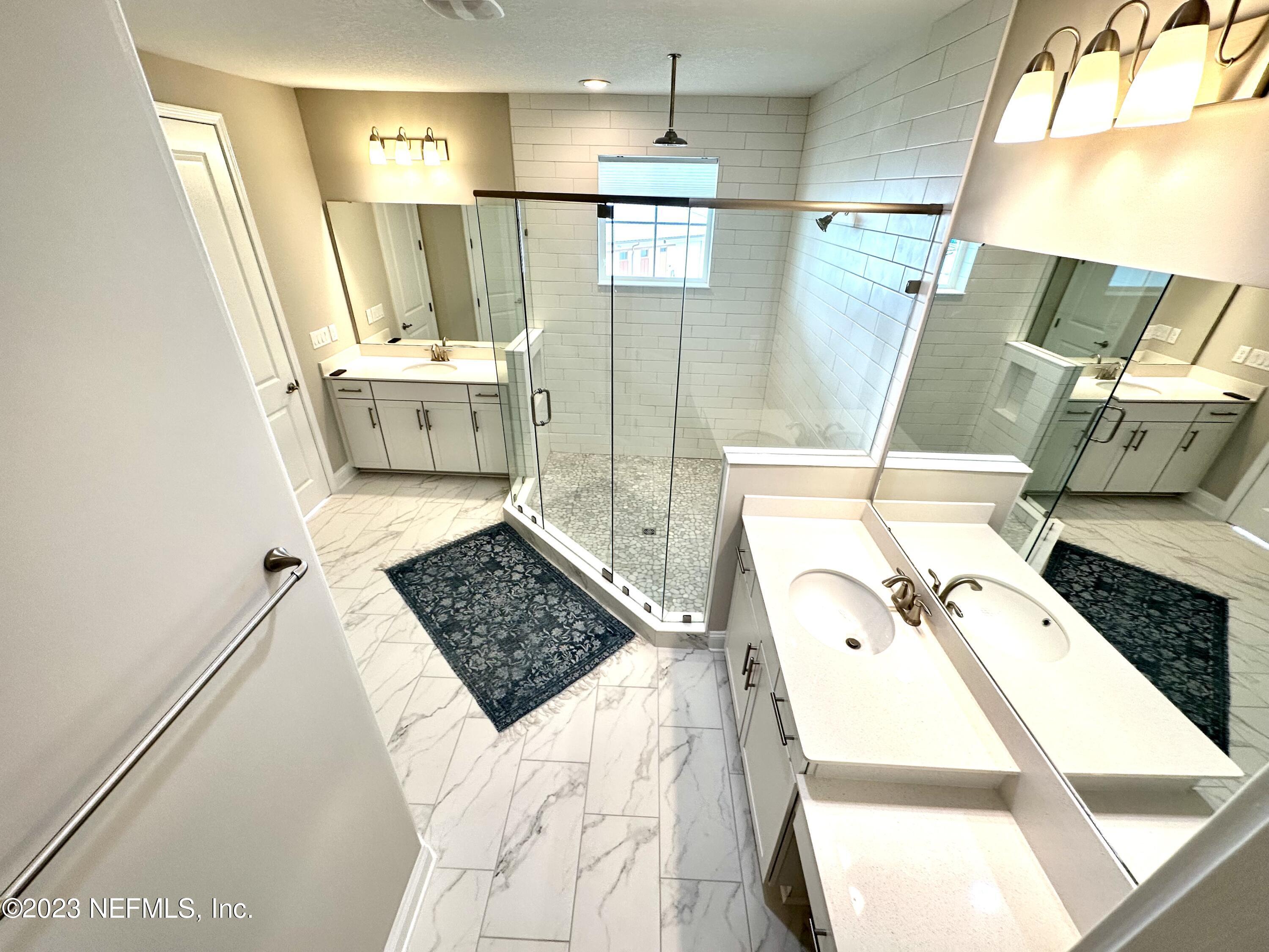 481 Marquesa Circle St. Johns, FL 32259 - Photo 48 of 53 a bathroom with a tub sink and a mirror