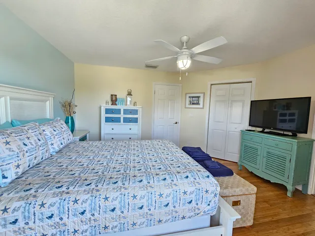 a bedroom with a large bed and a flat screen tv