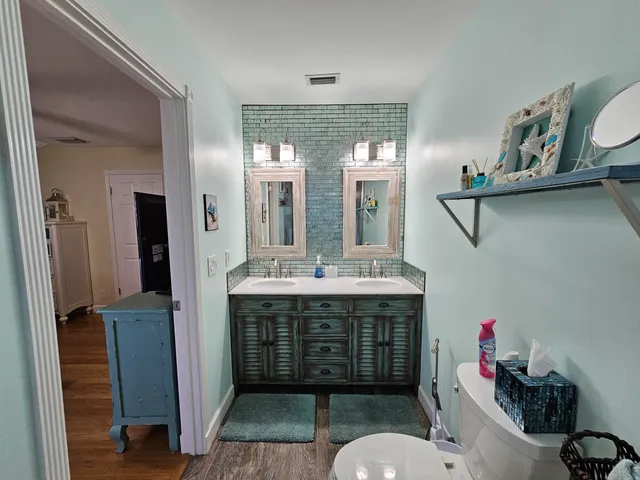 a view of living room with furniture and wooden floor