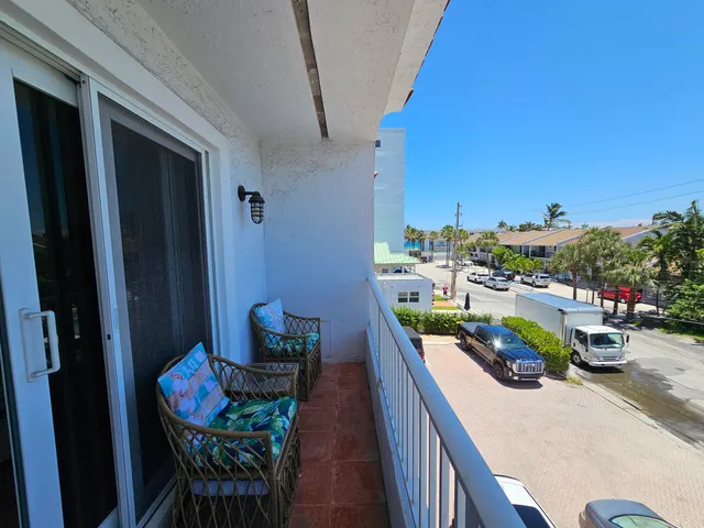 an aerial view of a balcony with chairs