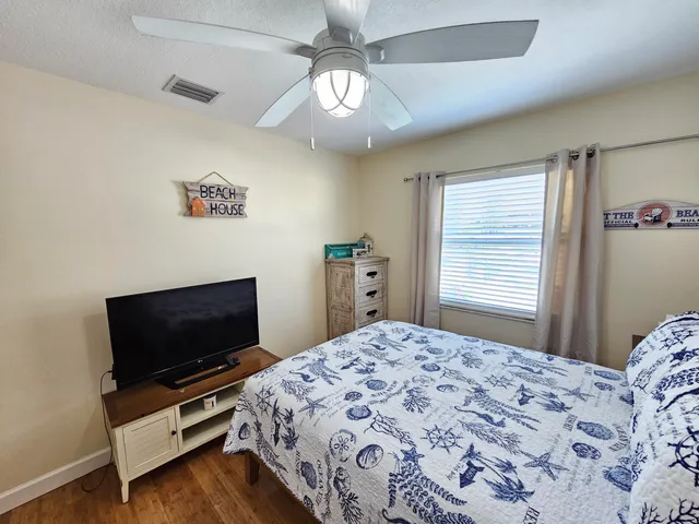 a bedroom with a bed and a flat screen tv