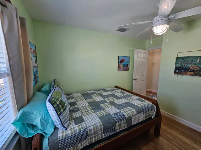 a bed sitting in a bedroom next to a window