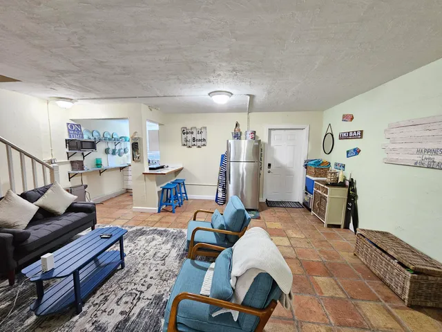 a living room with furniture and a rug