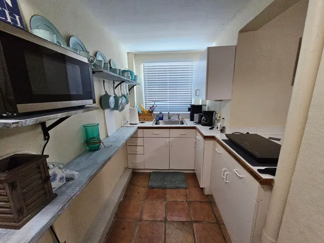 a kitchen that has a sink and a stove