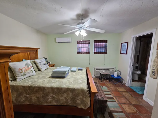 a bedroom with a bed and a desk