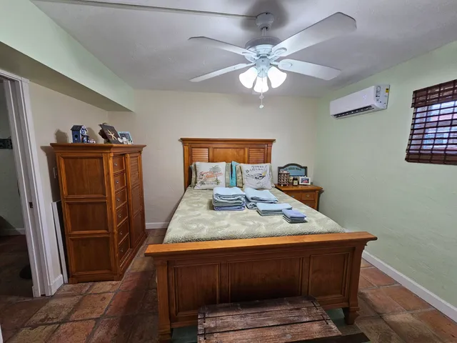 a bed sitting in a room next to a window