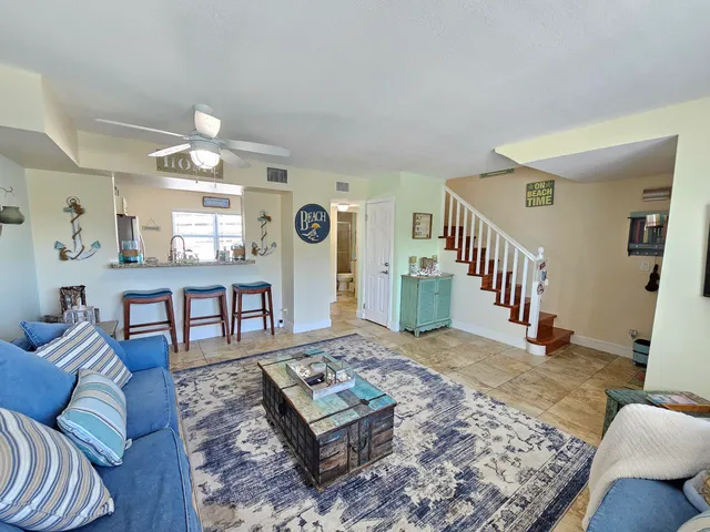a living room with furniture and a rug