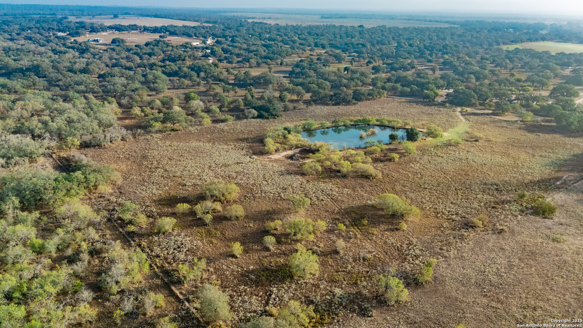 970 Newman Road Poteet, TX 78065 - Photo 15 of 30 an aerial view of residential houses with outdoor space and trees