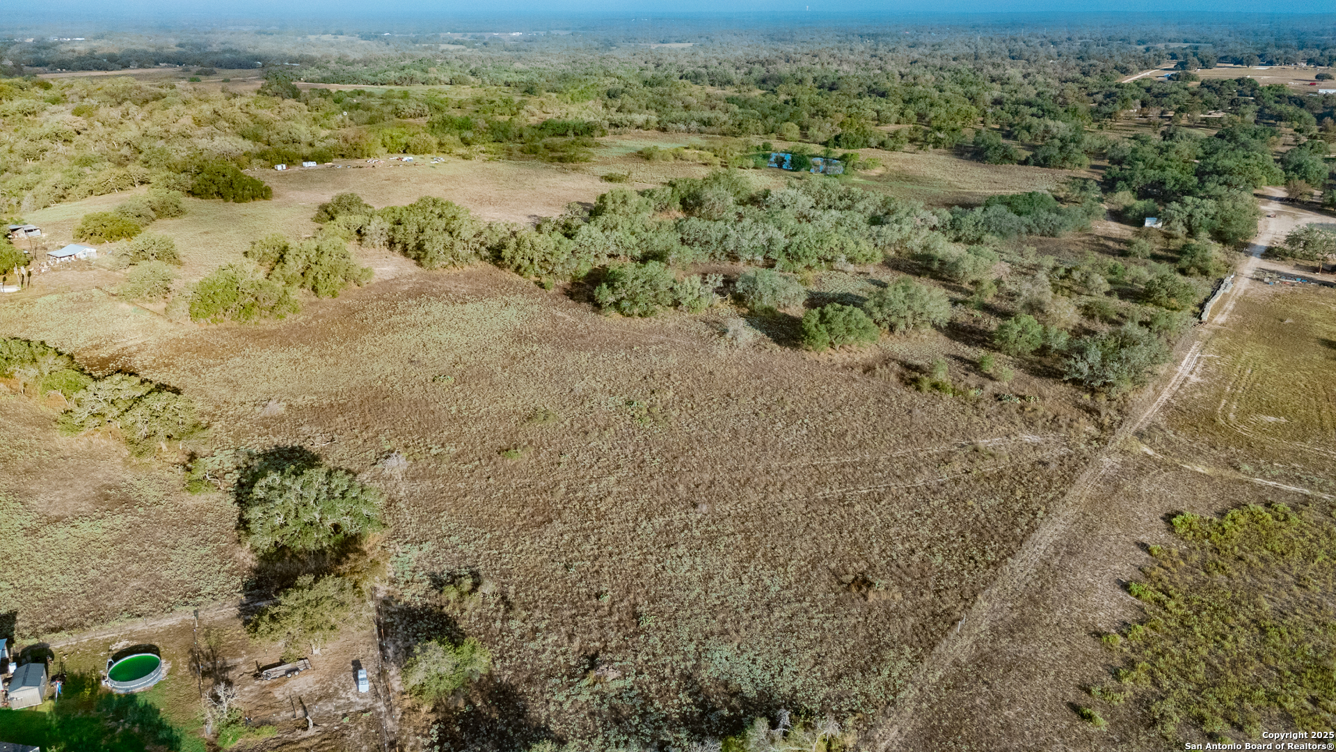 970 Newman Road Poteet, TX 78065 - Photo 17 of 30 a view of a yard with a house