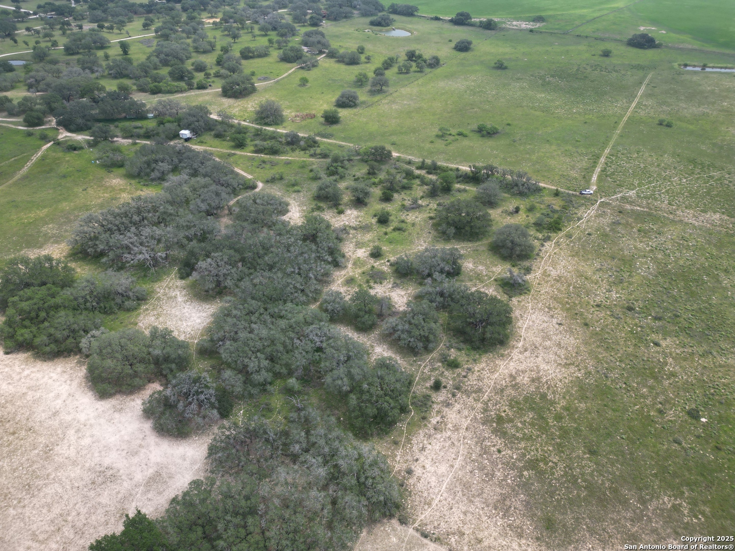 970 Newman Road Poteet, TX 78065 - Photo 25 of 30 a view of a dry yard with green space and fog