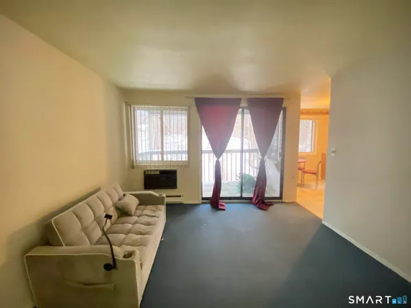 a living room with furniture and a window