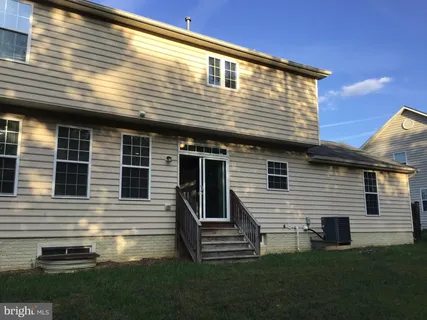 a view of a backyard with a wooden fence