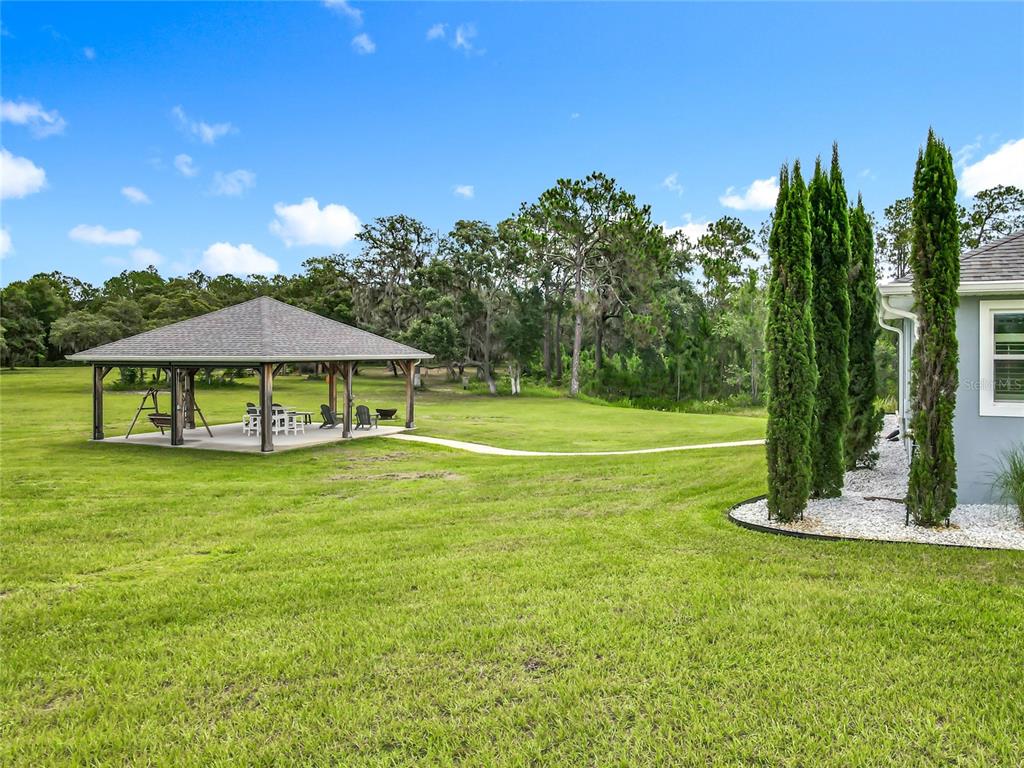 10220 Bay Lake Road Groveland, FL 34736 - Photo 62 of 67 a view of a house with a yard