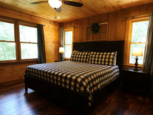 a bedroom with a bed table and window