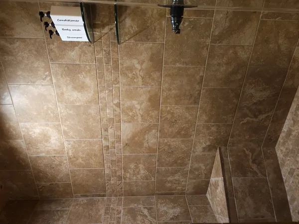 a bed sitting in a spacious bedroom next to a window