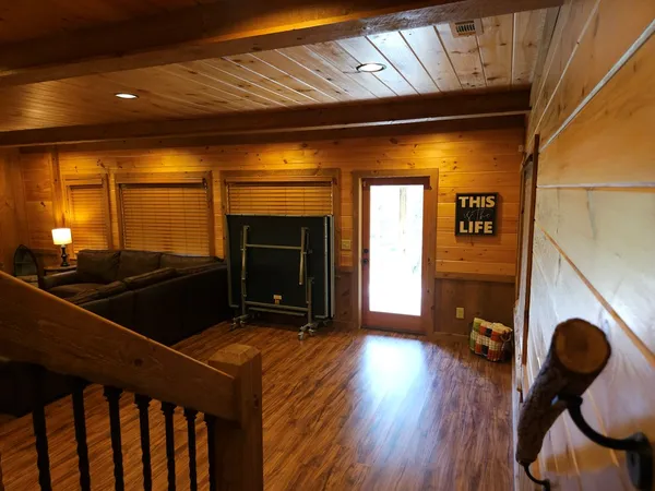 a room with wooden floor and windows