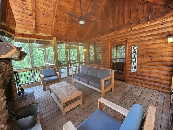 a outdoor living space with furniture and a fireplace
