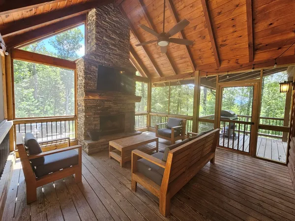 a living room with furniture and a large window with outer view