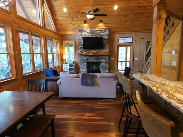 a living room with furniture a fireplace and a flat screen tv