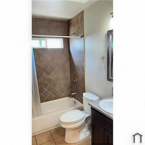 a bathroom with a toilet and shower